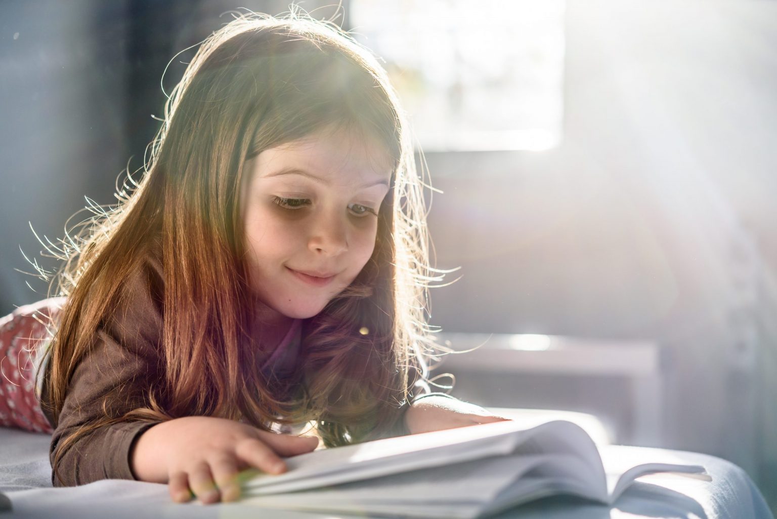 Girl Reading a Book at Home