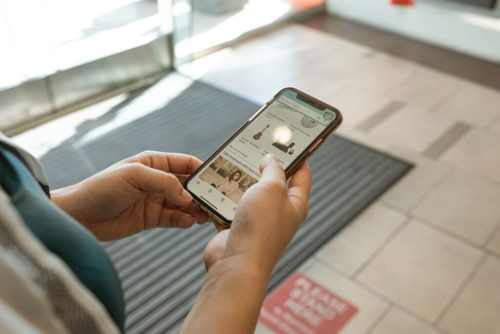 Hands holding a smartphone with an online shopping app open