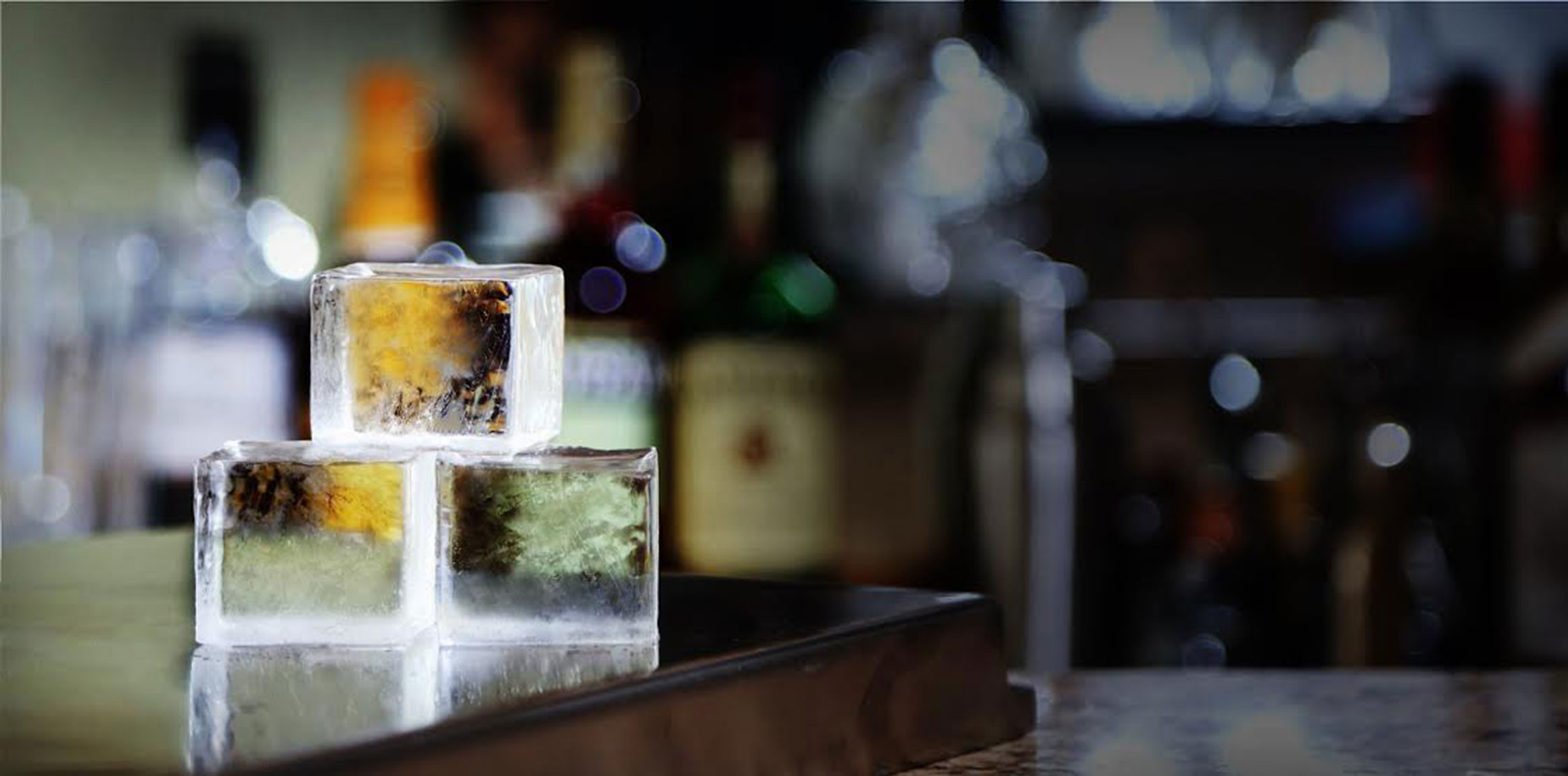 True Cubes clear ice tray with large clear cubes on a bar top